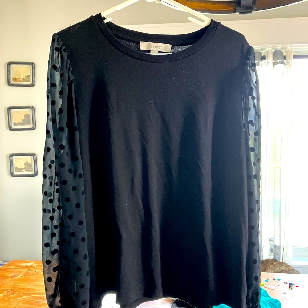 Black women’s top with sheer polkadot sleeves